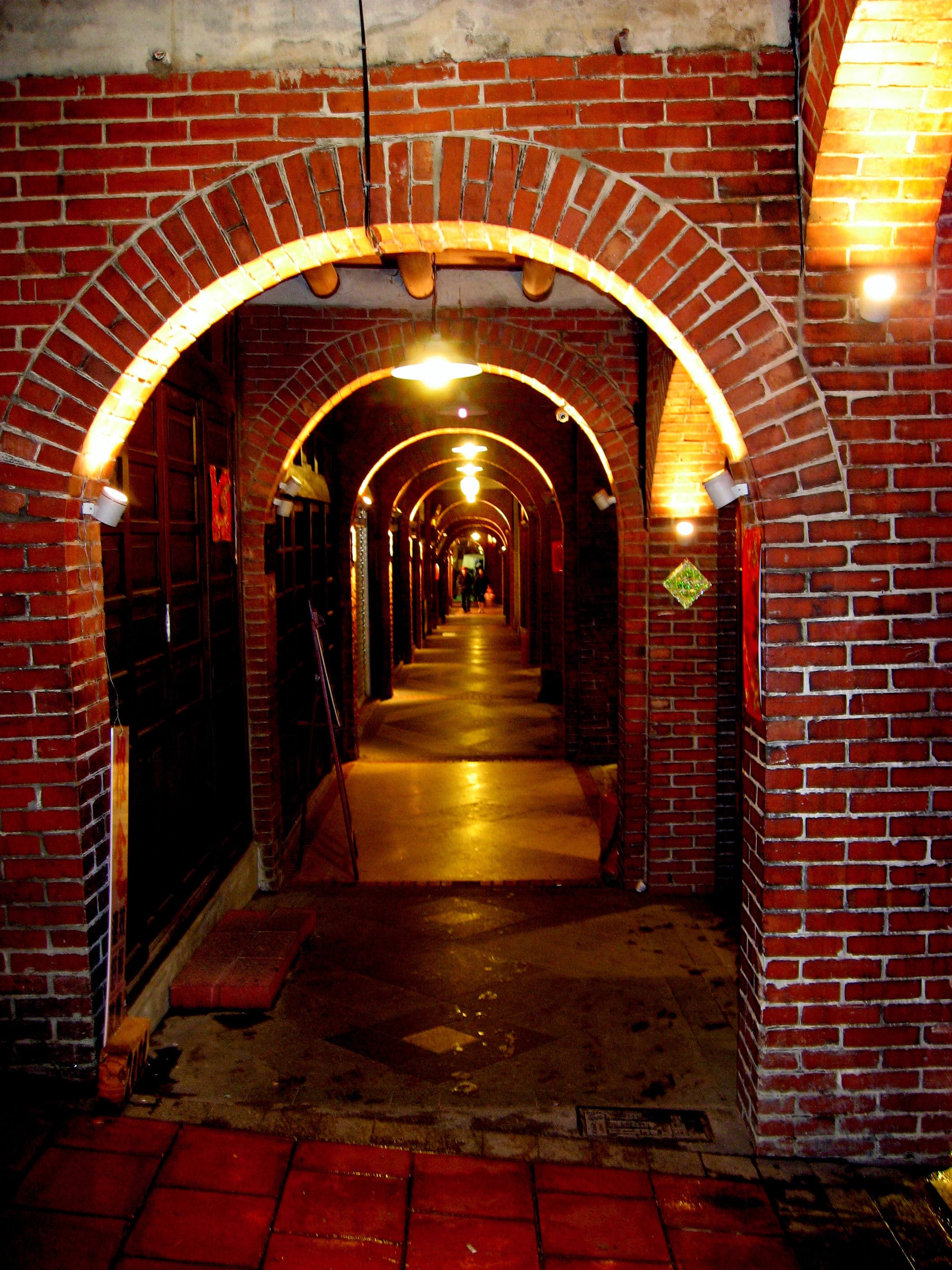 A sequence of red-brick arcades lit at night on Sanxia Minquan Old Street